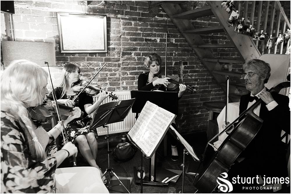 Creative candid photographs capturing the guests enjoying the fabulous relaxed setting at the Barn Wedding Venue in Lichfield by Walsall Wedding Photographers Stuart James