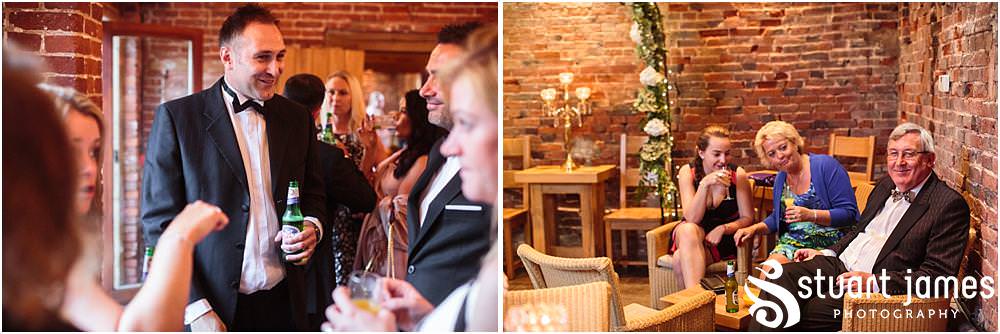 Creative candid photographs capturing the guests enjoying the fabulous relaxed setting at the Barn Wedding Venue in Lichfield by Walsall Wedding Photographers Stuart James