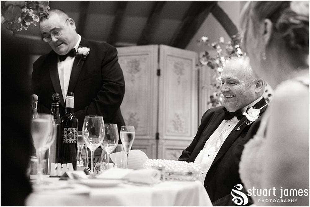 Creative storytelling photographs capturing the speeches and the fabulous emotional and entertaining reactions to the wedding speeches at the Barn Wedding Venue in Lichfield by Walsall Wedding Photographers Stuart James