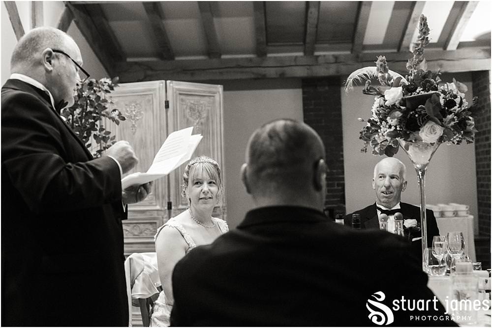 Creative storytelling photographs capturing the speeches and the fabulous emotional and entertaining reactions to the wedding speeches at the Barn Wedding Venue in Lichfield by Walsall Wedding Photographers Stuart James