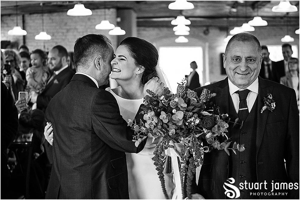 Documenting the entrance of the bride into the wedding ceremony at The West Mill in Derby by West Mill Wedding Photographers Stuart James
