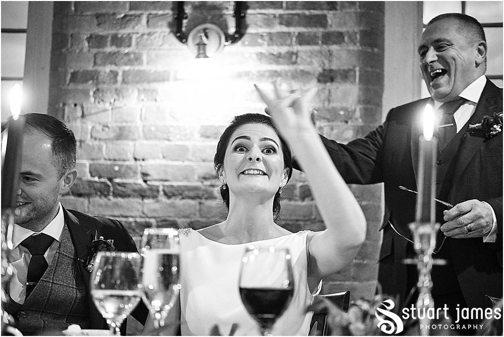 Creative photographs of the wedding speeches, capturing the speech by the Father of the Bride and the fabulous reactions from the guests at The West Mill in Derby by West Mill Wedding Photographers Stuart James