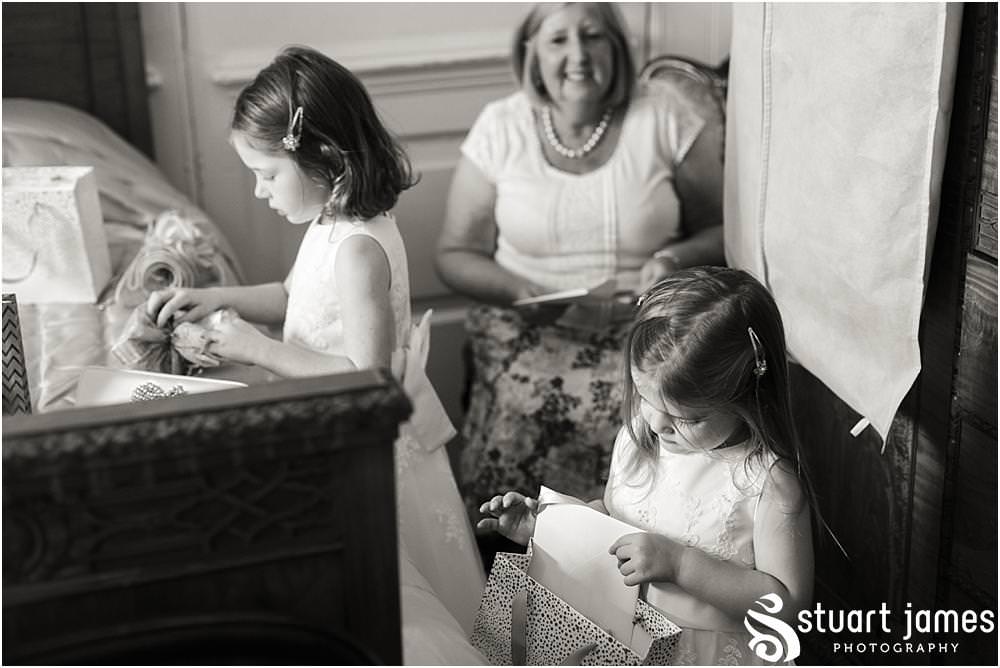 Capturing the emotions for the bridal party as the beautiful thoughtful presents are given to the bridesmaids at Davenport House in Shropshire by Davenport House Wedding Photographers Stuart James