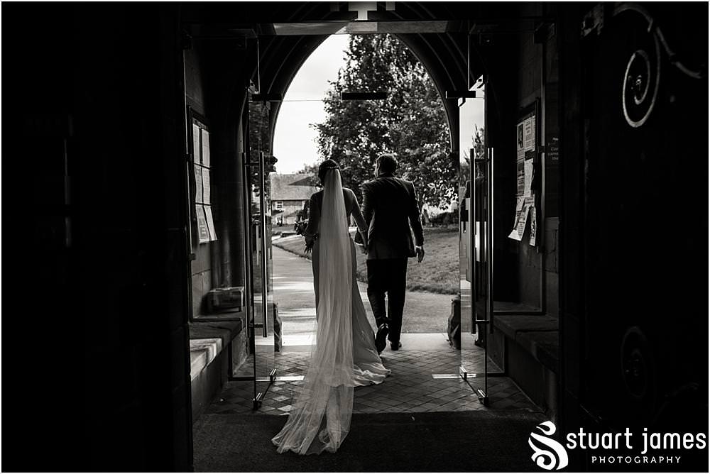 Beautiful candid photographs as the guests greet the Bride and Groom at St Chads Church in Pattingham by Davenport House Wedding Photographers Stuart James