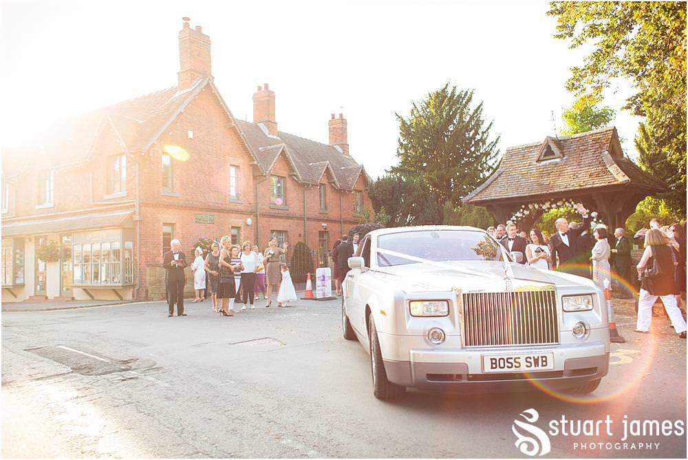 Beautiful candid photographs as the guests greet the Bride and Groom at St Chads Church in Pattingham by Davenport House Wedding Photographers Stuart James