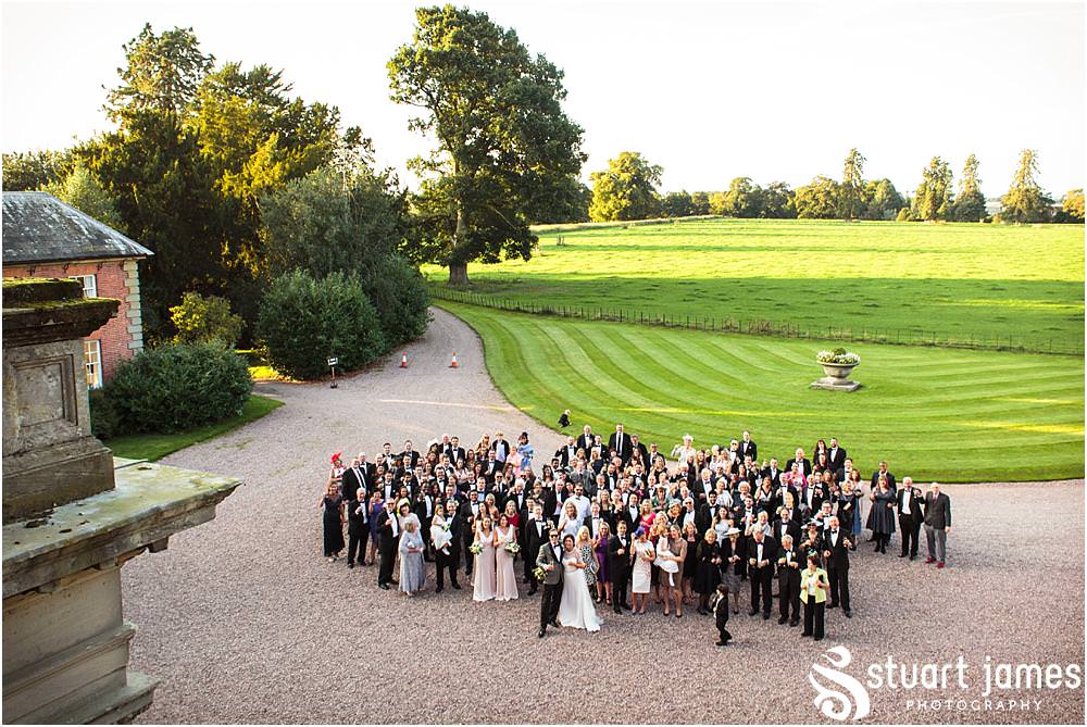 Natural photographs capturing the guests enjoying the drinks reception in the sun at Davenport House in Shropshire by Davenport House Wedding Photographers Stuart James