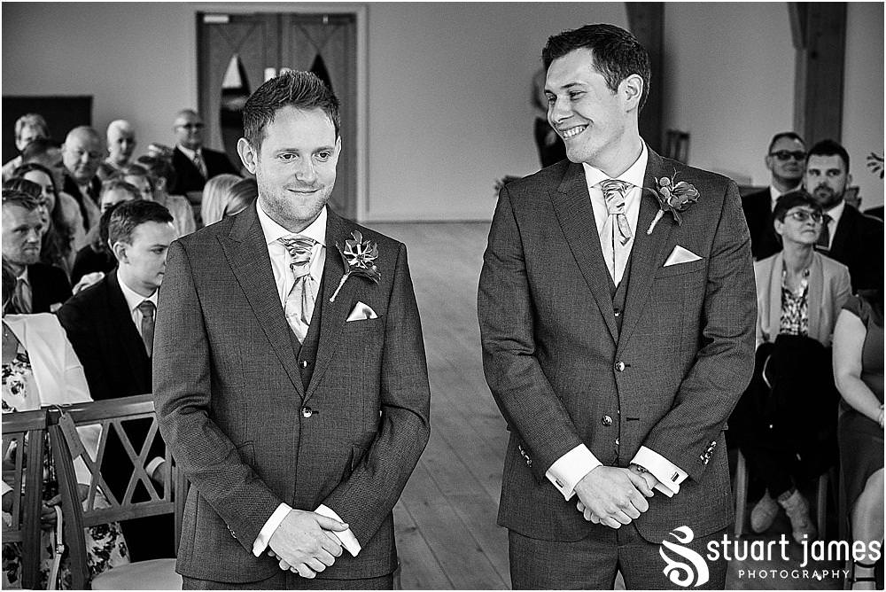 Capturing the emotions and the excitement as the bridal party process into the barn for the wedding ceremony at The Mill Barns in Alveley by Mill Barns Wedding Photographers Stuart James