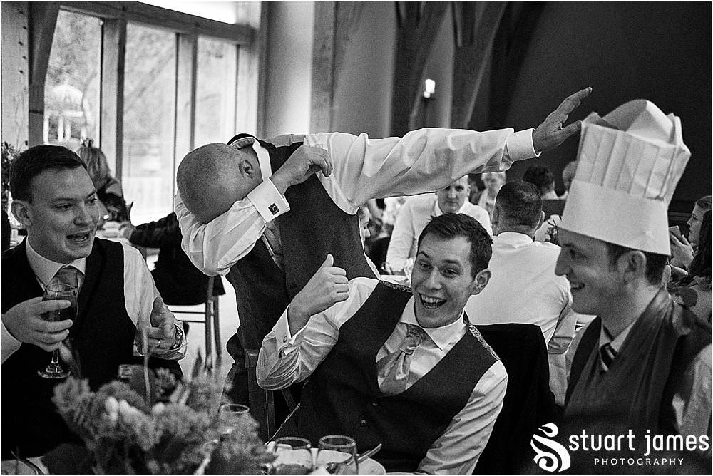 Creative candid photographs of the guests enjoying the wedding breakfast at The Mill Barns in Alveley by Mill Barns Wedding Photographers Stuart James