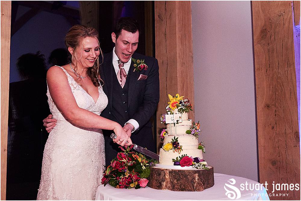 Cake cutting fun at The Mill Barns in Alveley by Mill Barns Wedding Photographers Stuart James