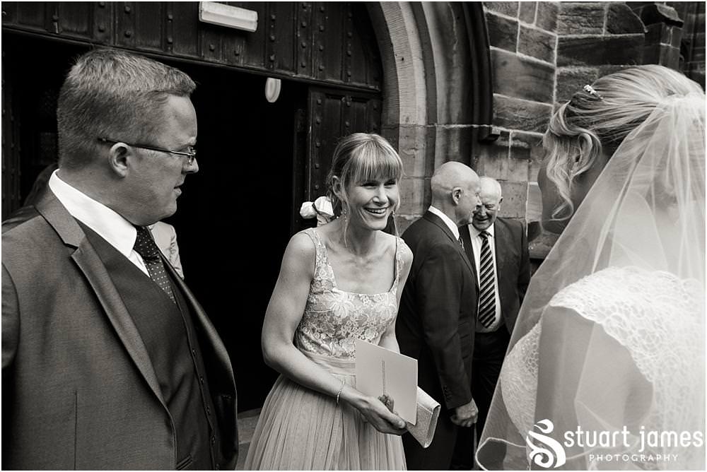 Beautiful scenes captured as the guests greet the Bride and Groom at St Michaels Church in Penkridge by Wedding Photographer Penkridge - Documentary Wedding Photographer Stuart James
