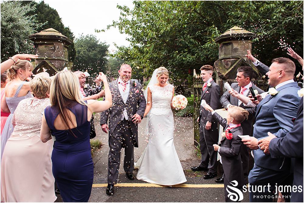 Beautiful scenes captured as the guests greet the Bride and Groom at St Michaels Church in Penkridge by Wedding Photographer Penkridge - Documentary Wedding Photographer Stuart James