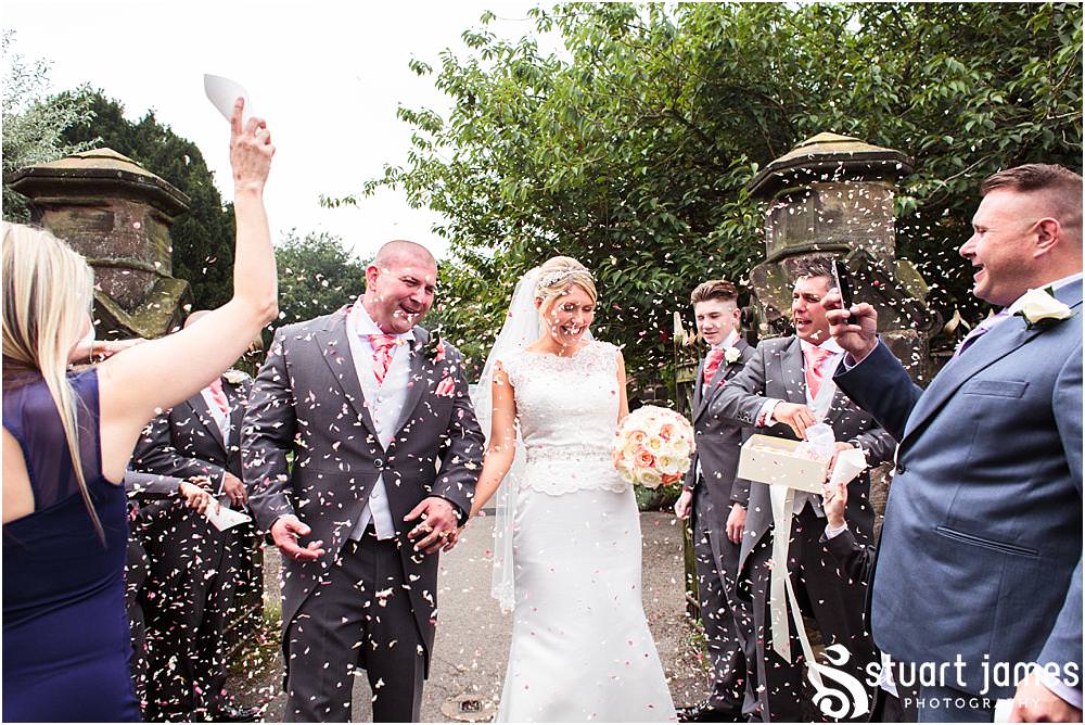 Beautiful scenes captured as the guests greet the Bride and Groom at St Michaels Church in Penkridge by Wedding Photographer Penkridge - Documentary Wedding Photographer Stuart James