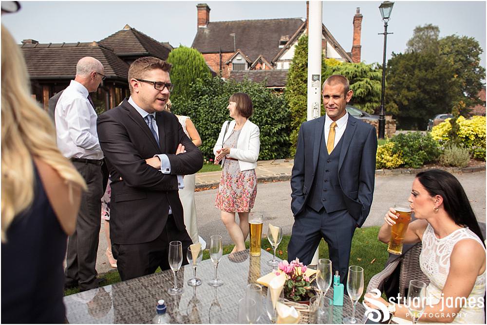Creative candid photographs showing the wedding guests enjoying the reception at The Moat House in Acton Trussell by Wedding Photographer Penkridge - Documentary Wedding Photographer Stuart James