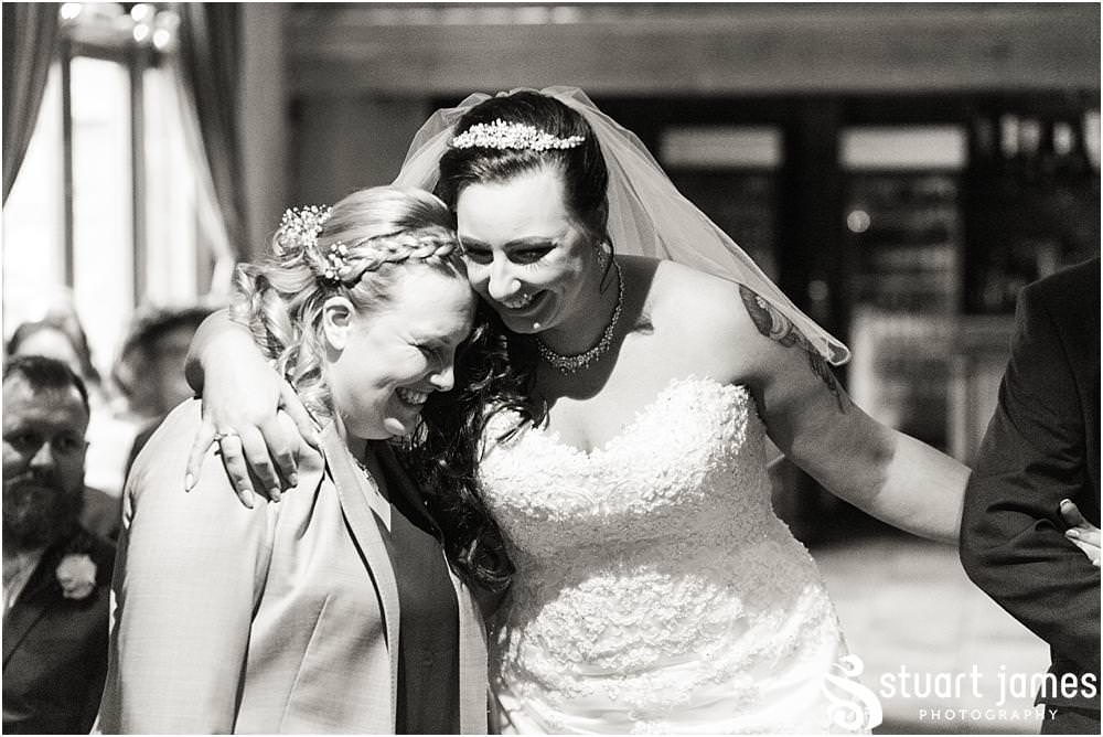 Photos that show the emotion during the entrance of the bridal party to the Tythe Barn at The Hundred House in Norton, Telford - Hundred House Wedding Photography by Documentary Wedding Photographer Stuart James