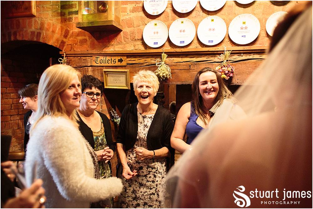Creative candid moments captured as the guests enjoy the drinks reception at The Hundred House in Norton, Telford - Hundred House Wedding Photography by Documentary Wedding Photographer Stuart James
