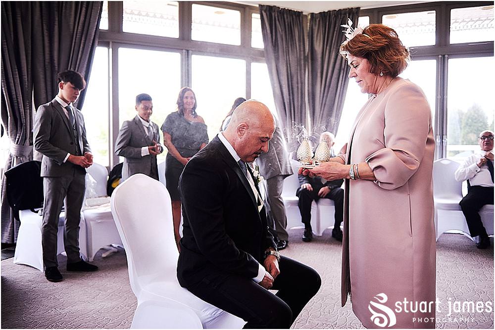 Candid photographs capturing the moments during the stolisma and the emotions of the guests at The Belfry in Birmingham by Greek Wedding Photographer Birmingham Stuart James