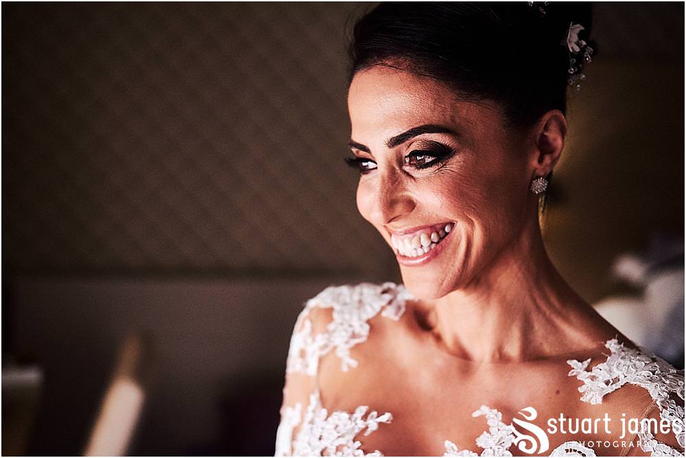 Incredible moments as the bride reveals her incredible gown to her waiting guests at The Belfry in Birmingham by Greek Wedding Photographer Birmingham Stuart James
