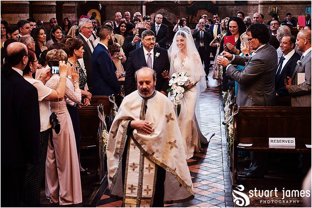 The entrance of the bridal party into the incredible setting at Greek Orthodox Church in Birmingham by Greek Wedding Photographer Birmingham Stuart James