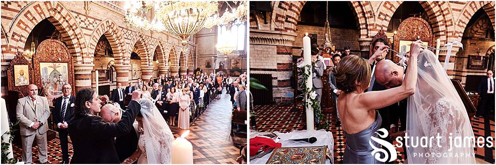 Creative photographs that unobtrusively capture the crown exchange during the wedding ceremony at Greek Orthodox Church in Birmingham by Greek Wedding Photographer Birmingham Stuart James
