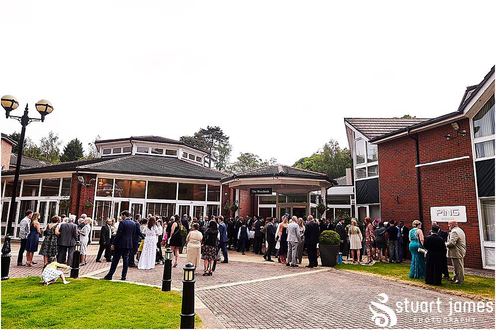 Creative candid photographs of the guests enjoying the drinks reception at The Belfry in Birmingham by Greek Wedding Photographer Birmingham Stuart James
