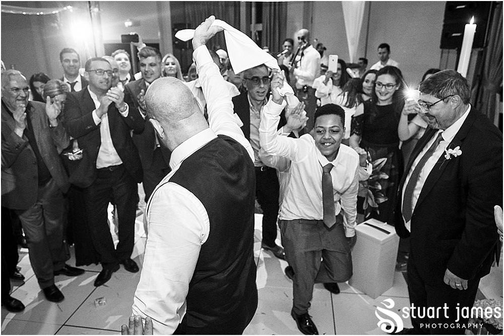 From right in the middle of the dance floor, really capturing the spirit of the wedding reception at The Belfry in Birmingham by Greek Wedding Photographer Birmingham Stuart James