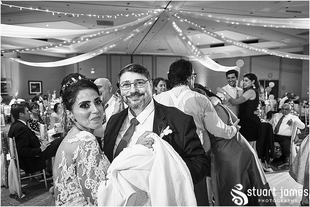 Fun creative candid images that really capture the fun of the evening reception at The Belfry in Birmingham by Greek Wedding Photographer Birmingham Stuart James