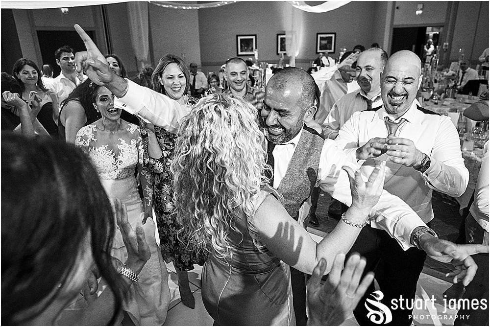From right in the middle of the dance floor, really capturing the spirit of the wedding reception at The Belfry in Birmingham by Greek Wedding Photographer Birmingham Stuart James
