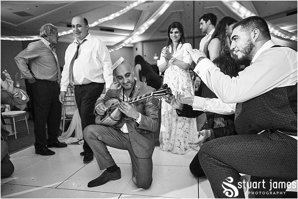 Fun creative candid images that really capture the fun of the evening reception at The Belfry in Birmingham by Greek Wedding Photographer Birmingham Stuart James