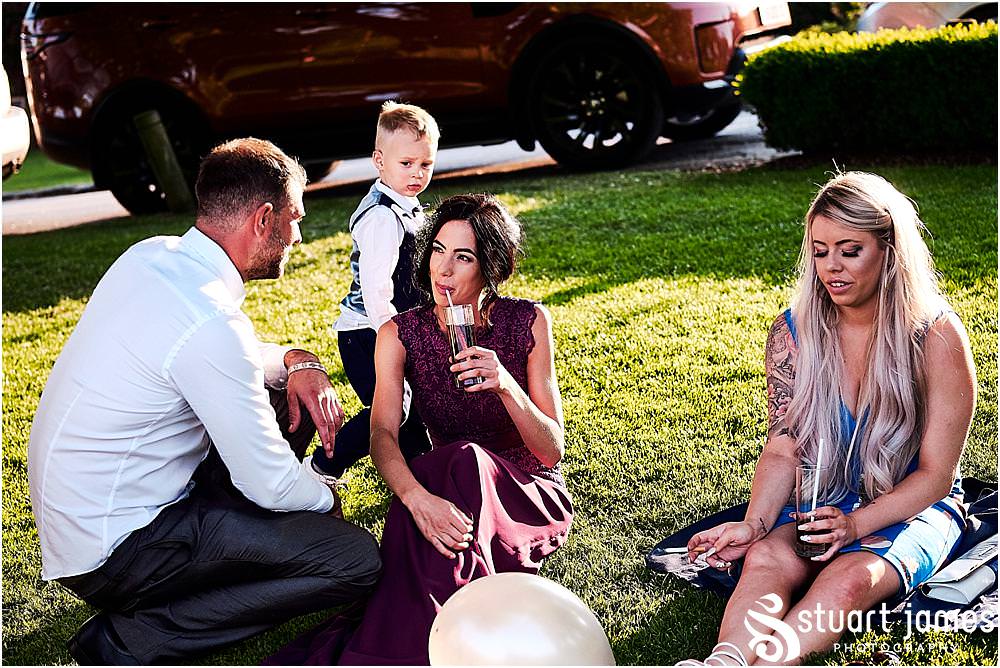 Capturing the evening reception with the guests enjoying the stunning weather and the casino entertainment at The Moat House in Stafford | Moat House Wedding Photographs by Documentary Wedding Photographer Stuart James