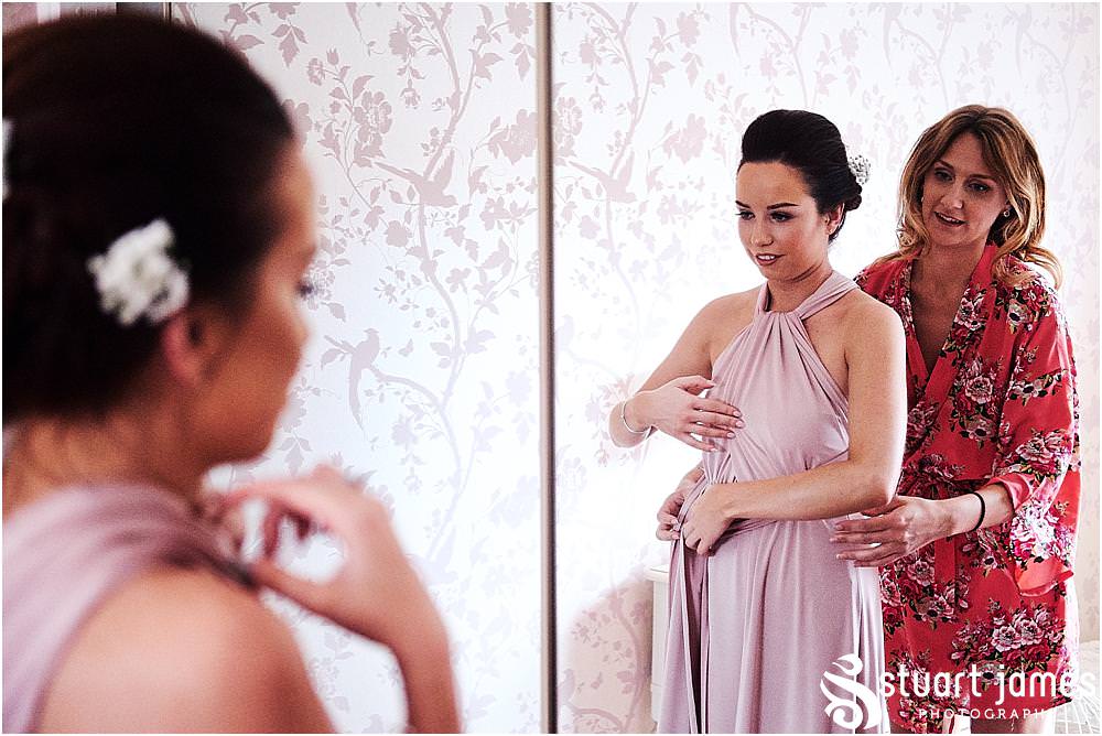 All hands-on-deck, helping each other prepare in the stunning dresses for the wedding at St Michaels Church by Penkridge Wedding Photographer Staffordshire Stuart James