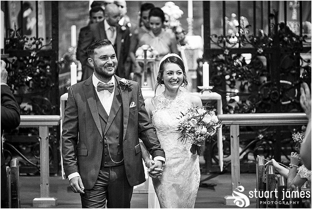 Such fabulous expressions seeing their guests greet them on their first journey down the aisle at St Michaels Church in Penkridge by Penkridge Wedding Photographer Staffordshire Stuart James