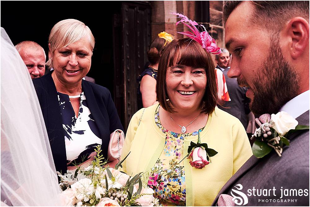 Creative candid photographs as the guests greet our bride and groom by Penkridge Wedding Photographer