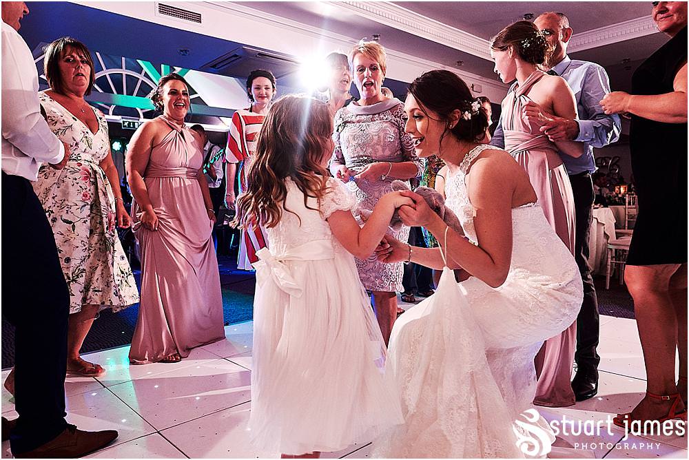 Lovely little moment to capture between the bride and the flower girl on the dance floor - creative evening photography by Penkridge Wedding Photographer