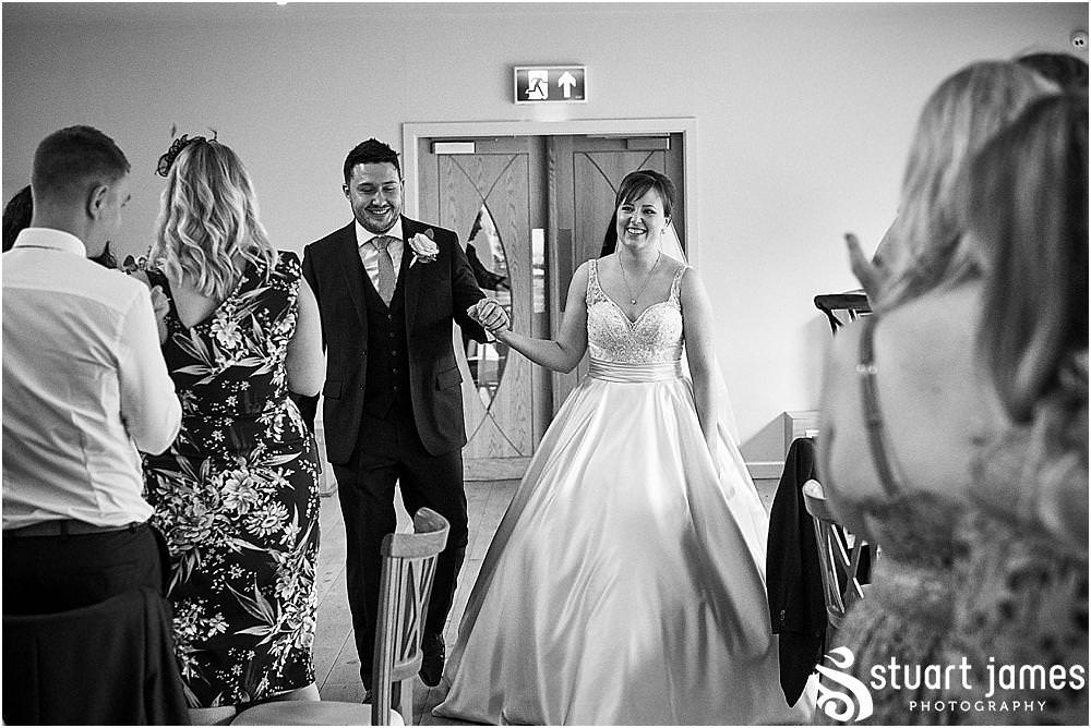 Documenting the entrance of the Bride and Groom to their waiting guests for the wedding breakfast at The Mill Barns photos by Mill Barns Wedding Photographer Stuart James