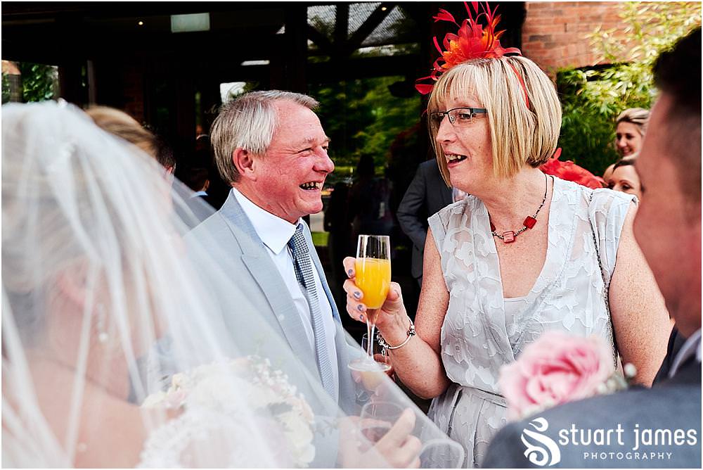 Creative candid photographs capturing the guests enjoying the drinks reception at The Moat House in Acton Trussell by Penkridge Wedding Photographer Stuart James