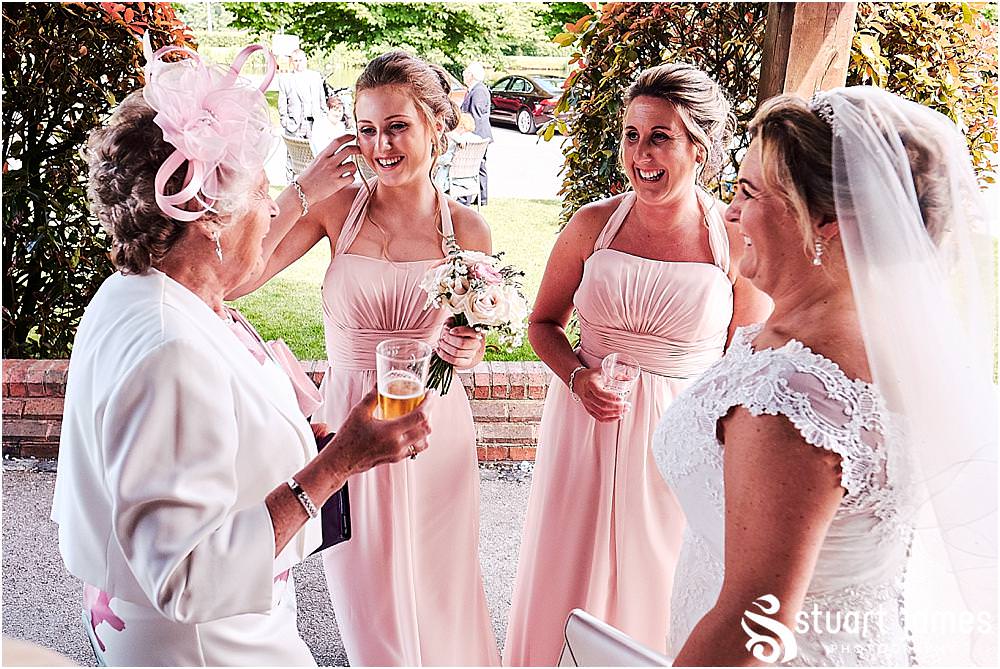Creative candid photographs capturing the guests enjoying the drinks reception at The Moat House in Acton Trussell by Penkridge Wedding Photographer Stuart James
