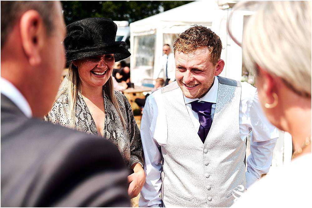 Creative candid photographs as the guests arrive ready to enjoy the amazing reception in the family field. Photos by Uttoxeter Wedding Photographer Stuart James