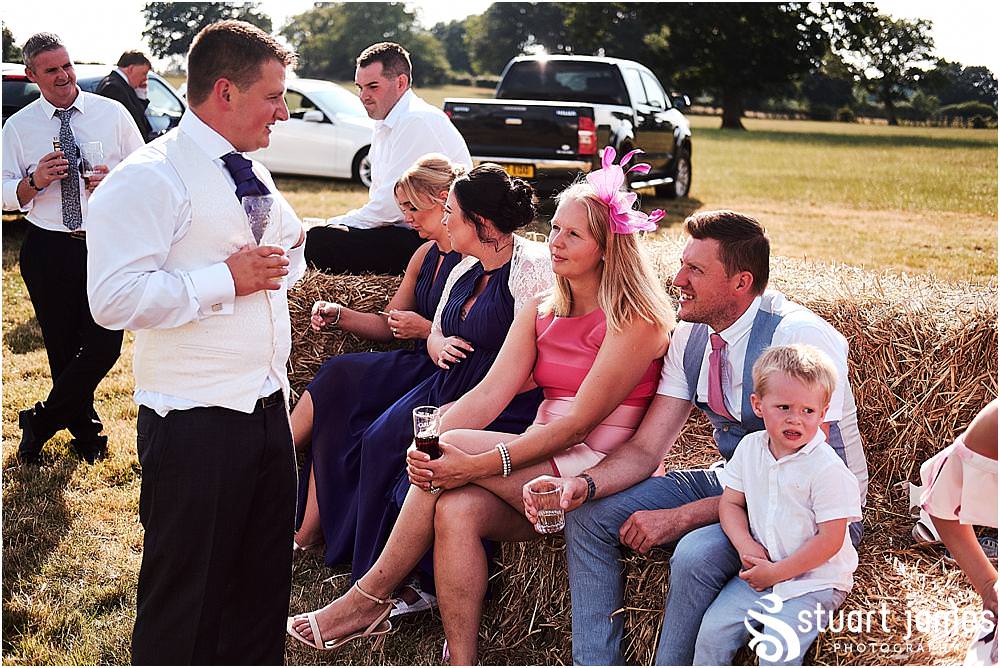 Reportage photos of the guests enjoying the amazing reception in the marquee in Bramshall. Photos by Uttoxeter Wedding Photographer Stuart James