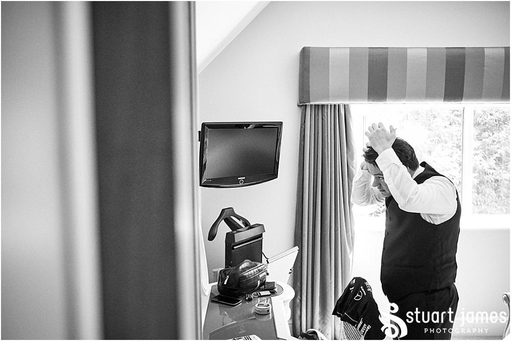 Candid photos as the groomsmen get ready for the wedding at Moxhull Hall in Sutton Coldfield by Moxhull Hall Wedding Photographer Stuart James