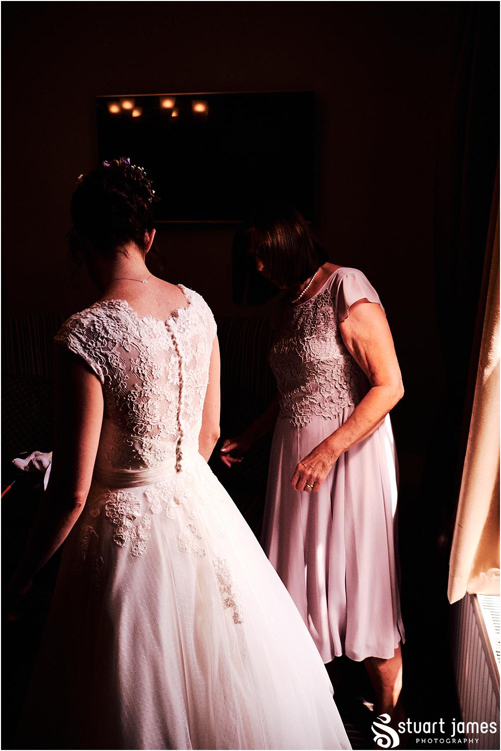 Capturing the excitement as our bride dresses ready for the wedding at Moxhull Hall in Sutton Coldfield by Moxhull Hall Wedding Photographer Stuart James