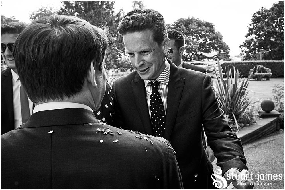 Fun candid photographs as the guests greet the new Mr & Mrs and enjoy the drinks reception on the lawns at Moxhull Hall in Sutton Coldfield by Moxhull Hall Wedding Photographer Stuart James