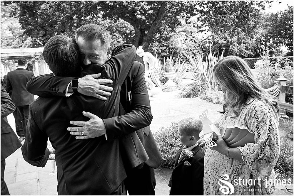 Fun candid photographs as the guests greet the new Mr & Mrs and enjoy the drinks reception on the lawns at Moxhull Hall in Sutton Coldfield by Moxhull Hall Wedding Photographer Stuart James