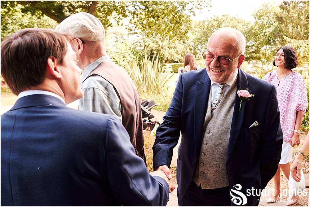 Fun candid photographs as the guests greet the new Mr & Mrs and enjoy the drinks reception on the lawns at Moxhull Hall in Sutton Coldfield by Moxhull Hall Wedding Photographer Stuart James