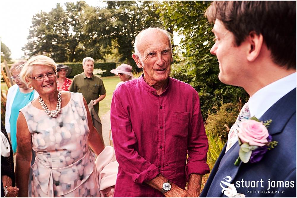 Fun candid photographs as the guests greet the new Mr & Mrs and enjoy the drinks reception on the lawns at Moxhull Hall in Sutton Coldfield by Moxhull Hall Wedding Photographer Stuart James