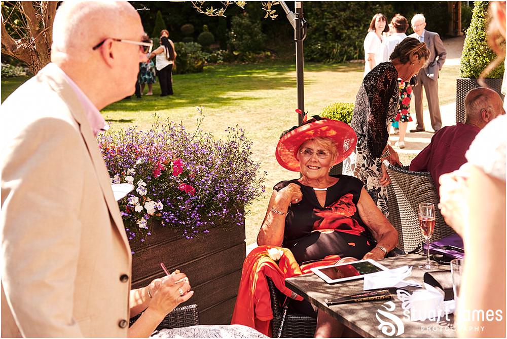 Fun candid photographs as the guests greet the new Mr & Mrs and enjoy the drinks reception on the lawns at Moxhull Hall in Sutton Coldfield by Moxhull Hall Wedding Photographer Stuart James