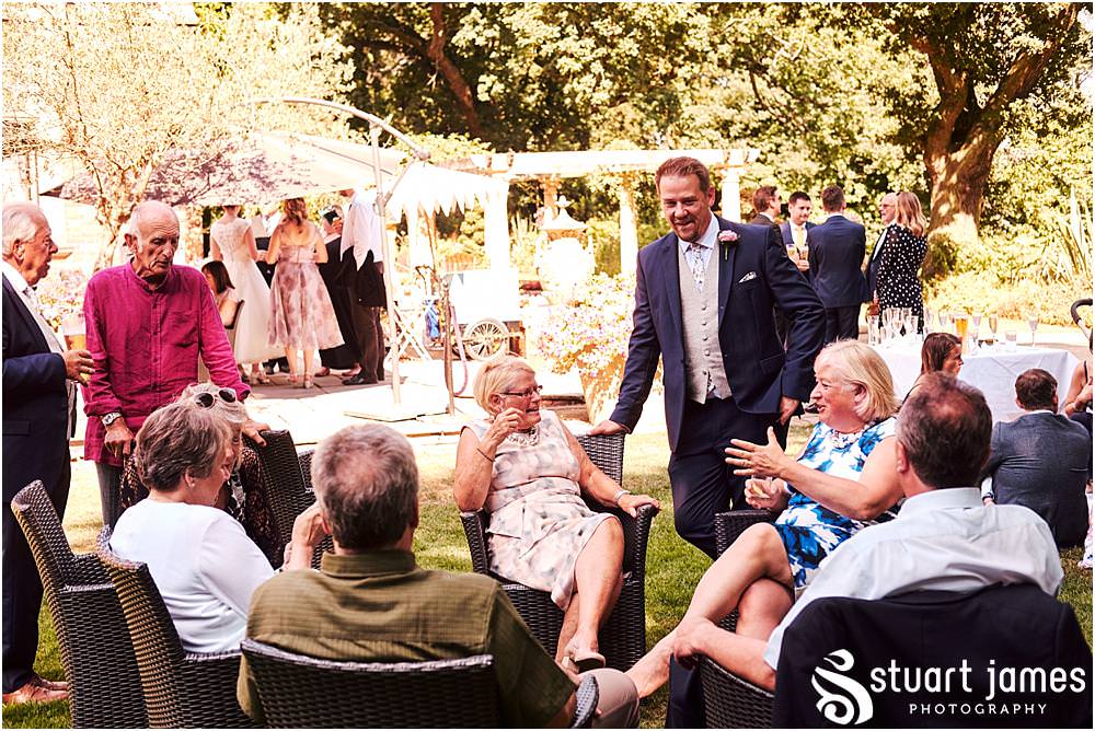 Relaxed reportage photographs capturing the atmosphere of the wedding reception as the guests enjoy the drinks in the amazing setting of Moxhull Hall in Sutton Coldfield by Moxhull Hall Wedding Photographer Stuart James