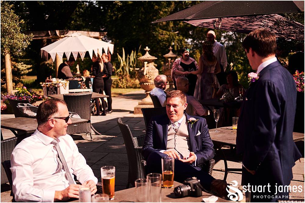 Relaxed reportage photographs capturing the atmosphere of the wedding reception as the guests enjoy the drinks in the amazing setting of Moxhull Hall in Sutton Coldfield by Moxhull Hall Wedding Photographer Stuart James