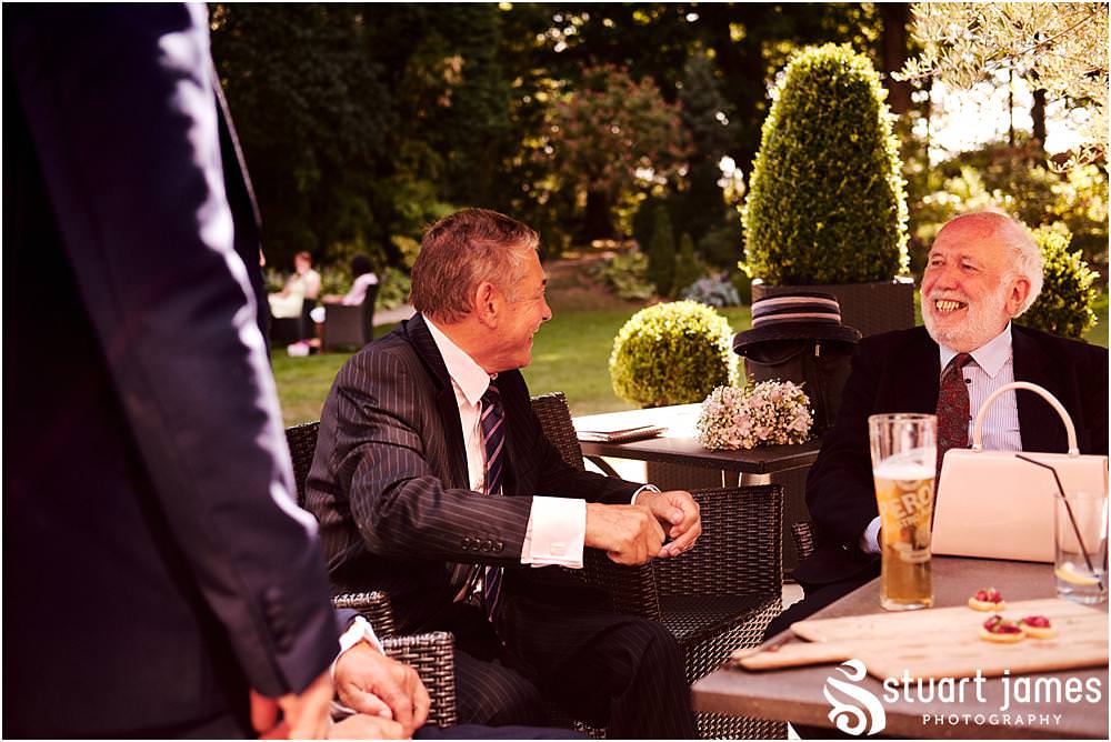 Relaxed reportage photographs capturing the atmosphere of the wedding reception as the guests enjoy the drinks in the amazing setting of Moxhull Hall in Sutton Coldfield by Moxhull Hall Wedding Photographer Stuart James