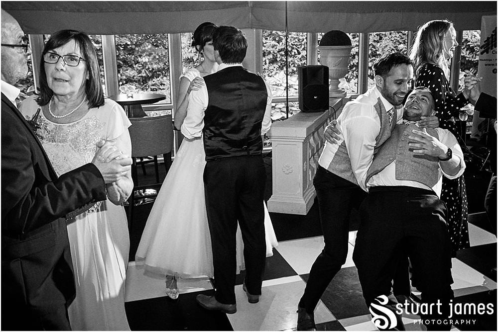 Capturing the fun of the reception as the guests love the ceilidh in the marquee at Moxhull Hall in Sutton Coldfield by Moxhull Hall Wedding Photographer Stuart James