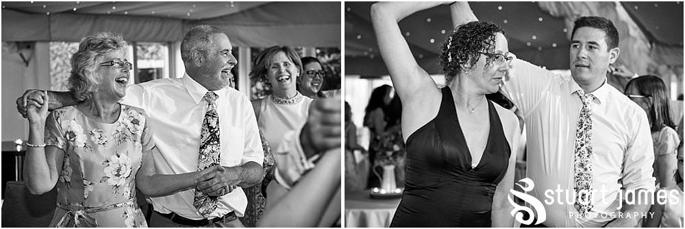 Capturing the fun of the reception as the guests love the ceilidh in the marquee at Moxhull Hall in Sutton Coldfield by Moxhull Hall Wedding Photographer Stuart James